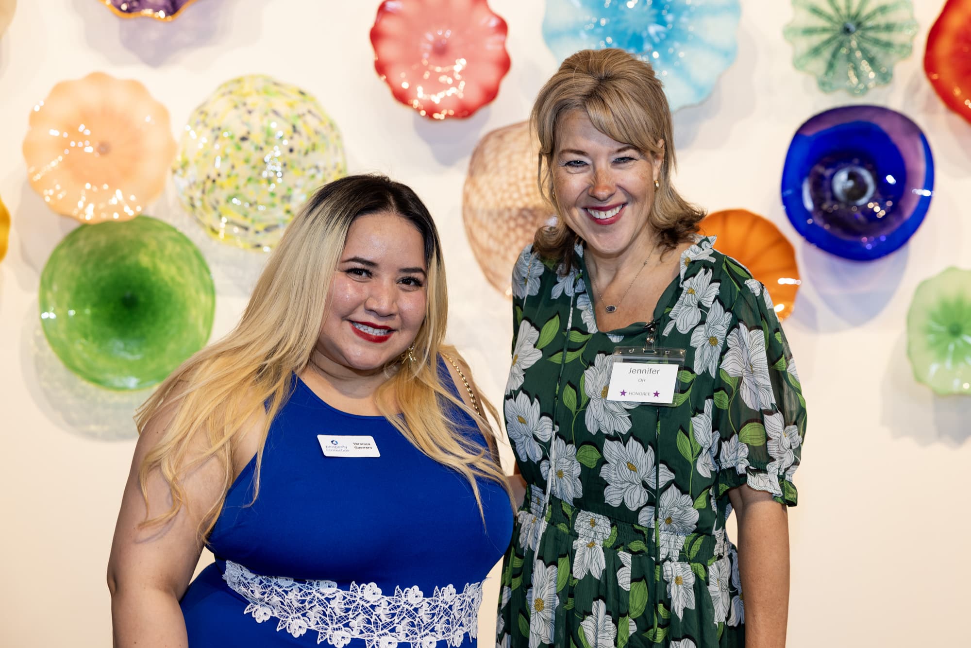 Jen Orr stands with her financial coach Veronica Guerrera as they celebrate her success.