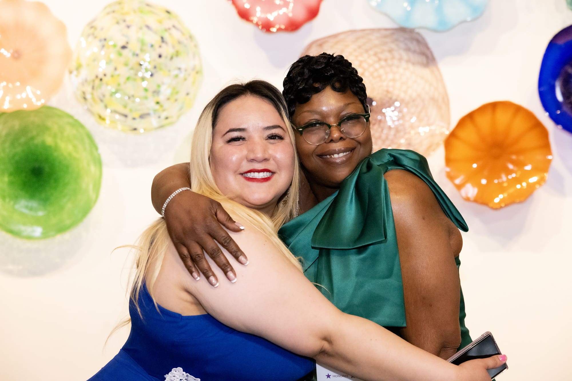 Tara Price embraces her financial coach Veronica Guerrera as they celebrate her success.