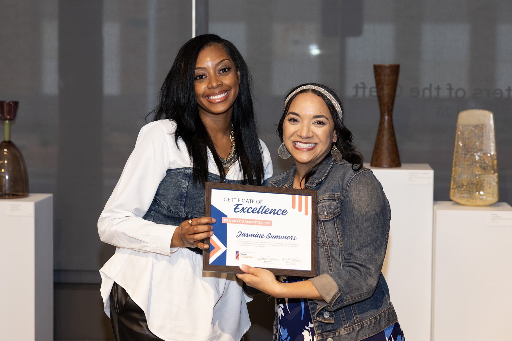 Jasmine Summers stands with her financial coach Ashley Morgan as they celebrate her success.