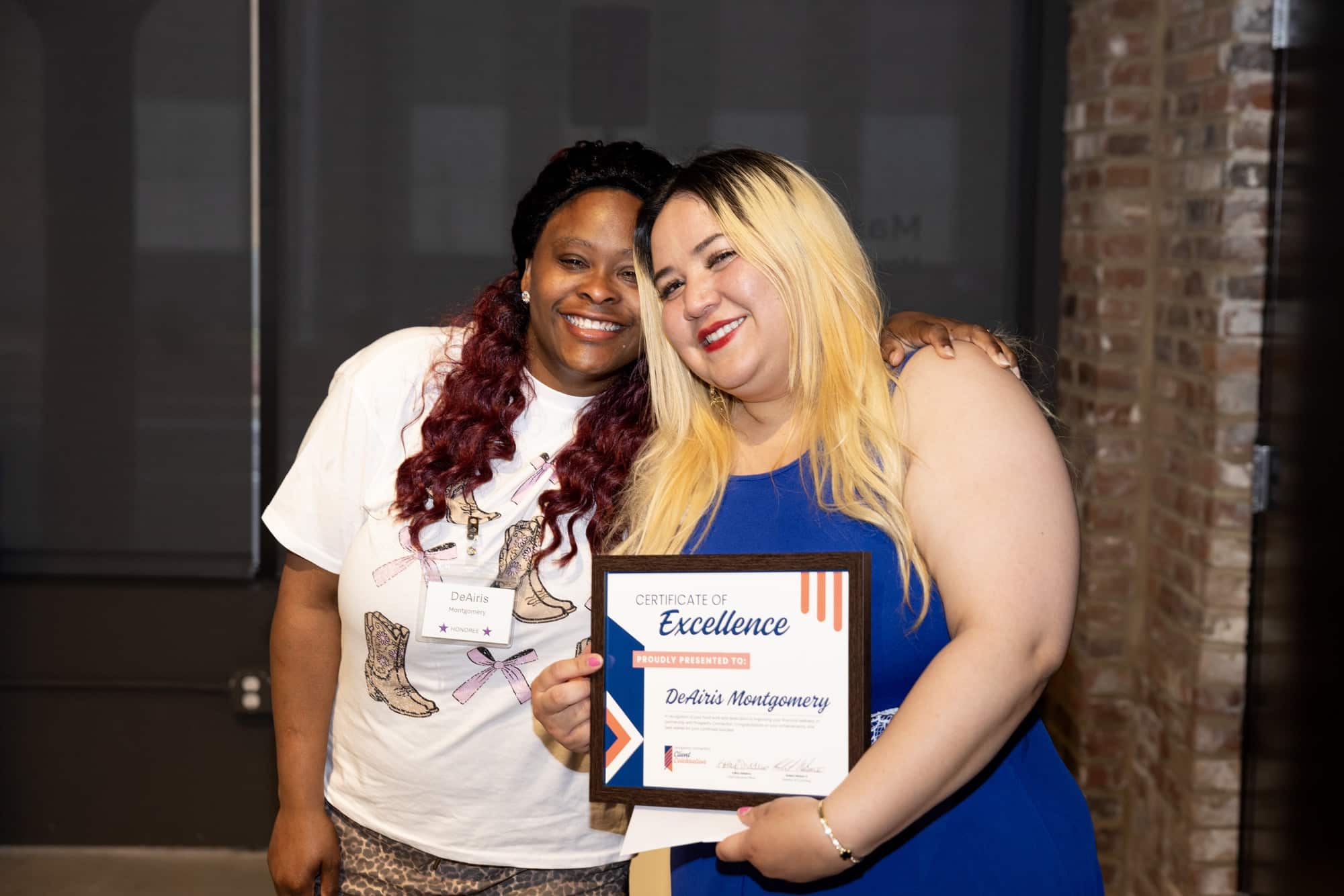 DeAiris Montgomery stands with her financial coach Veronica Guerrera as they celebrate her success.