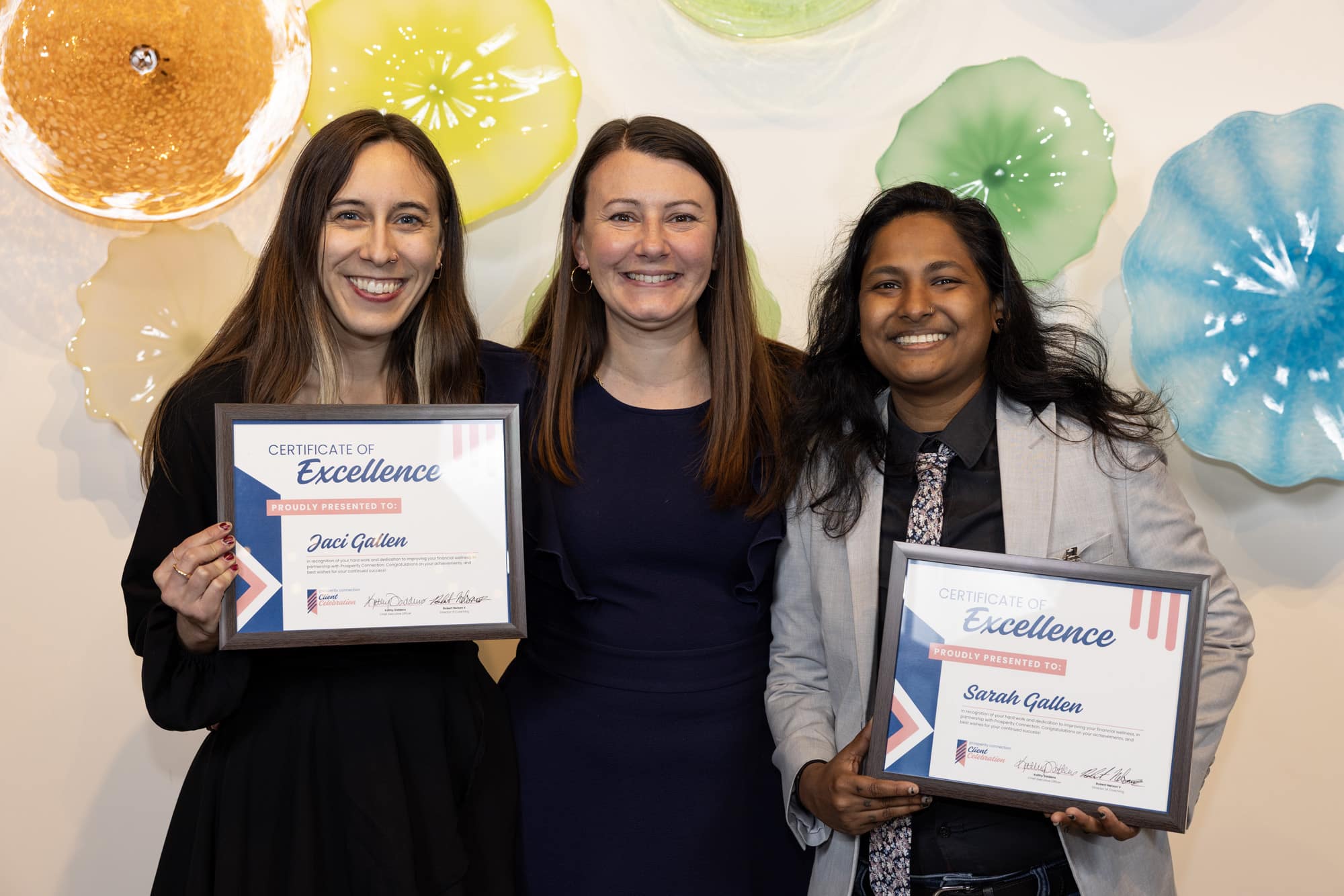 Sarah and Jaci Gallen stand with their financial coach Sasha Moore as they celebrate their success.