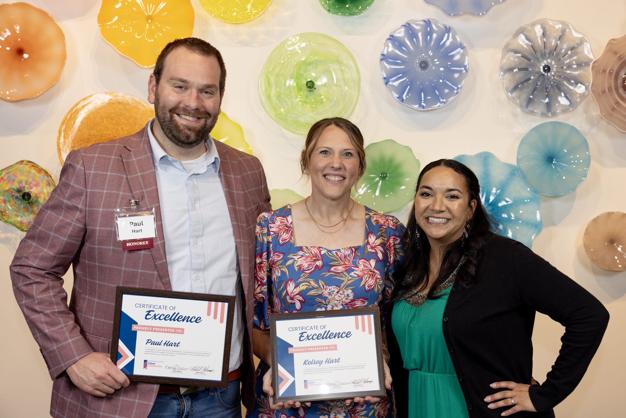 Paul & Kelsey Hart stand with their financial coach Ashlee Morgan as they celebrate their success.